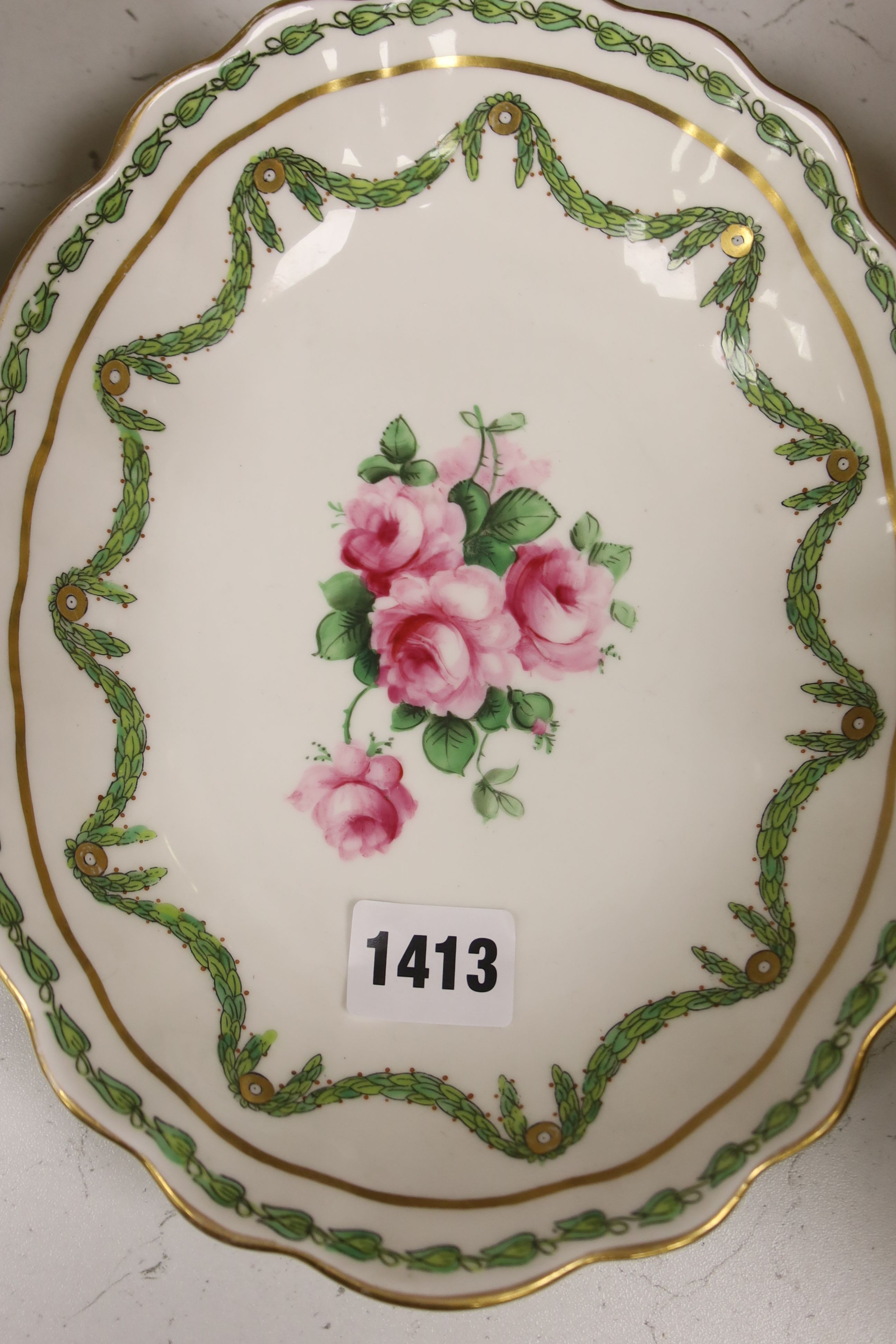 A quantity of 19th century hand painted floral plates, decorated with roses set within trailing garlands, marked T. Goode & Co, London